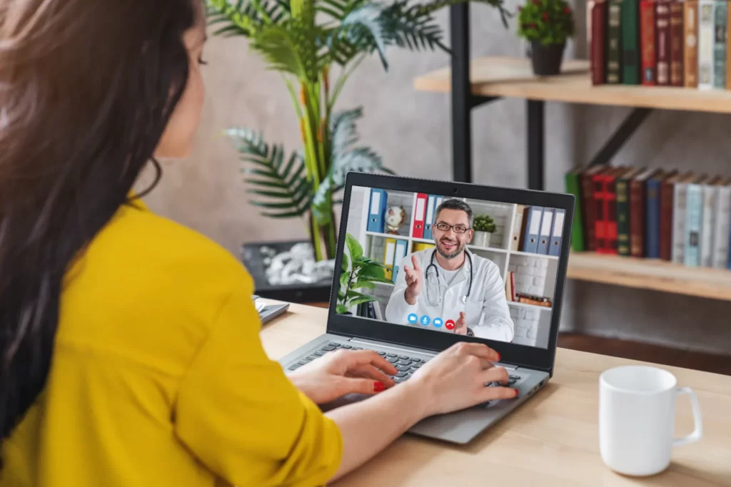 back view of woman making video call with her doct utc